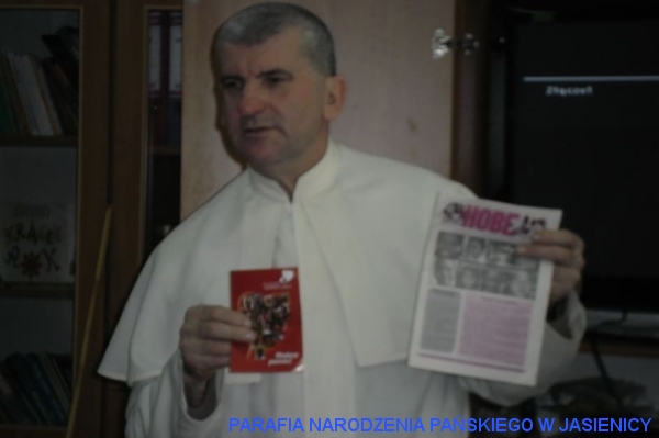 Ks. Misjonarz prezentuje gazetkę HOBE